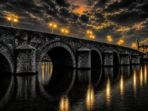 Sint Servaasbrug Maastricht schilderij met donkere brug, gouden verlichting en reflecties in de Maas